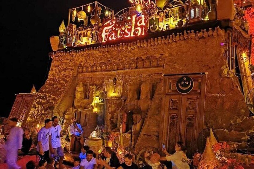 A large, ornate building with intricate carvings and a sign that reads 'Faisal.' 4