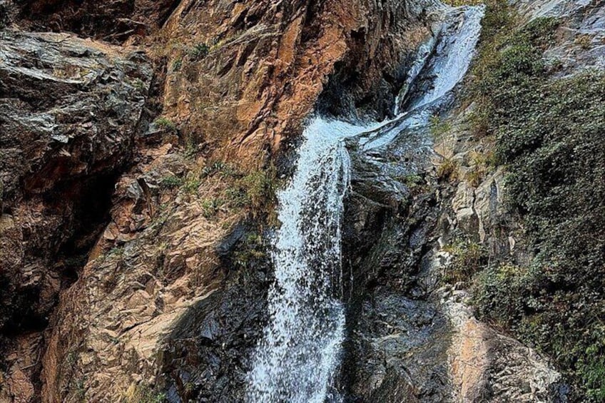 A waterfall cascading down a rocky cliff. 4