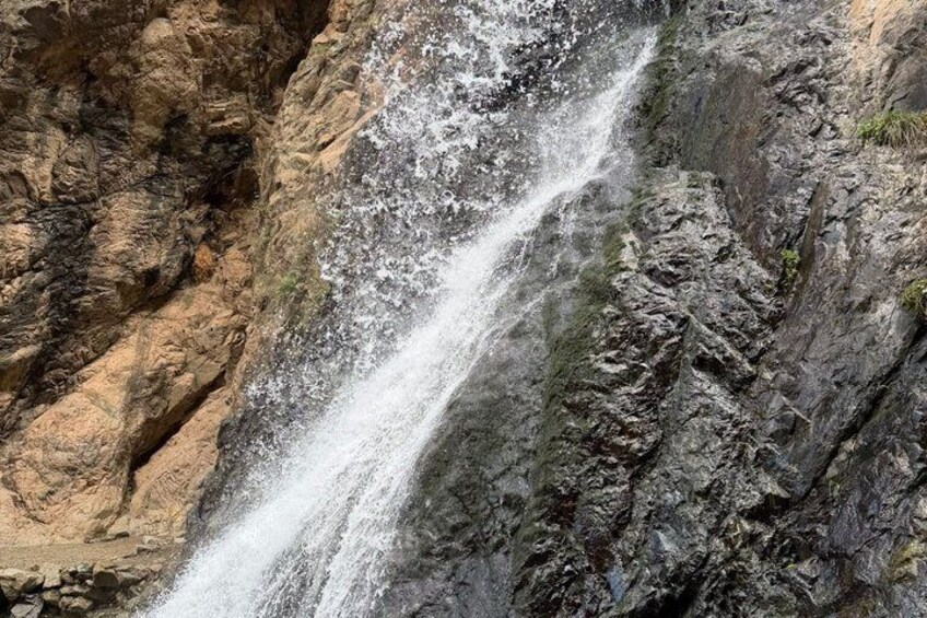 A waterfall cascading down a rocky cliff. 2