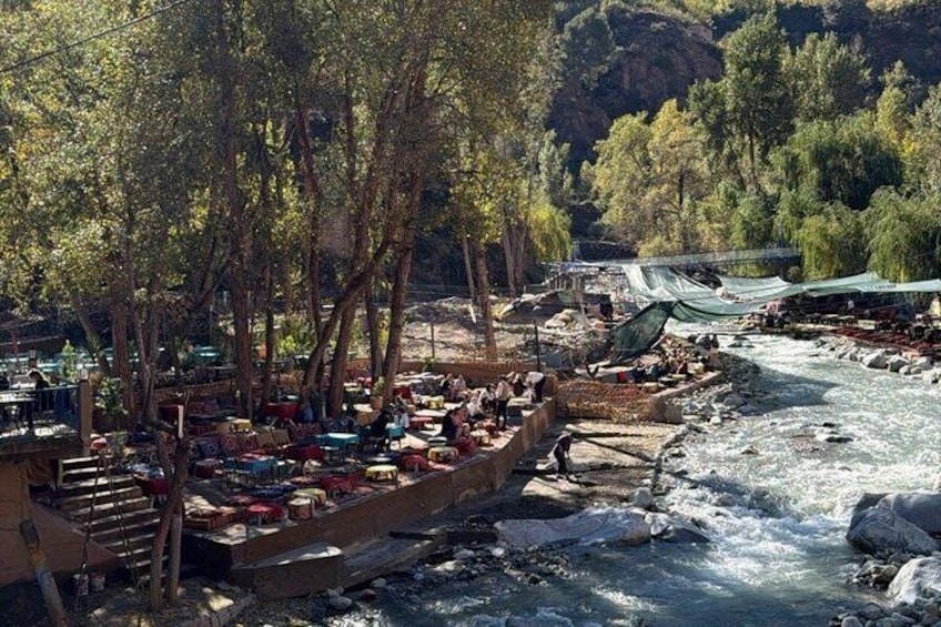 A riverside market with boats and tents. 5