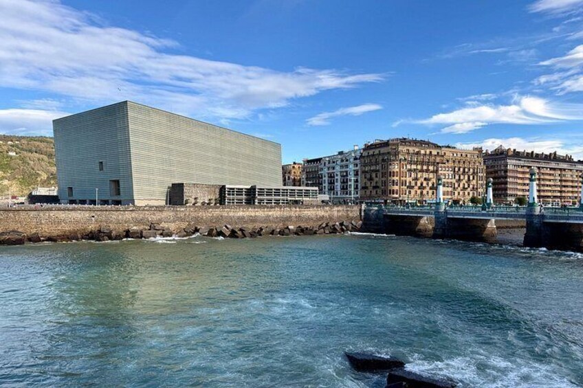 A river with a modern building and historic buildings in the background. 5