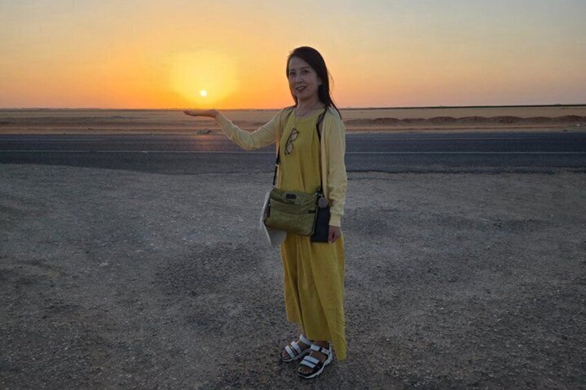 Une personne se tient sur une plage au coucher du soleil. 5