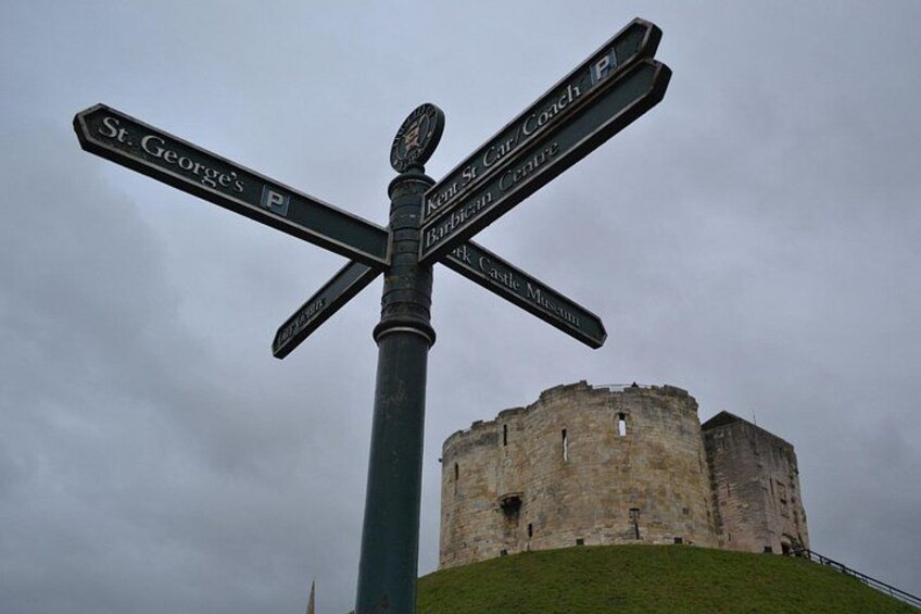 A directional signpost with multiple arms pointing to various destinations including St. George's, St. Mary's, and Black Castle Museum. 4