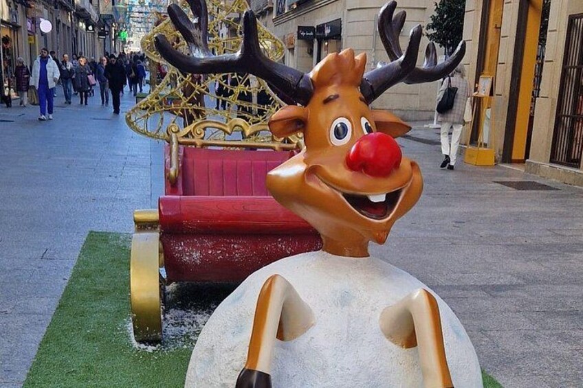 A reindeer statue with antlers and a red nose. 5