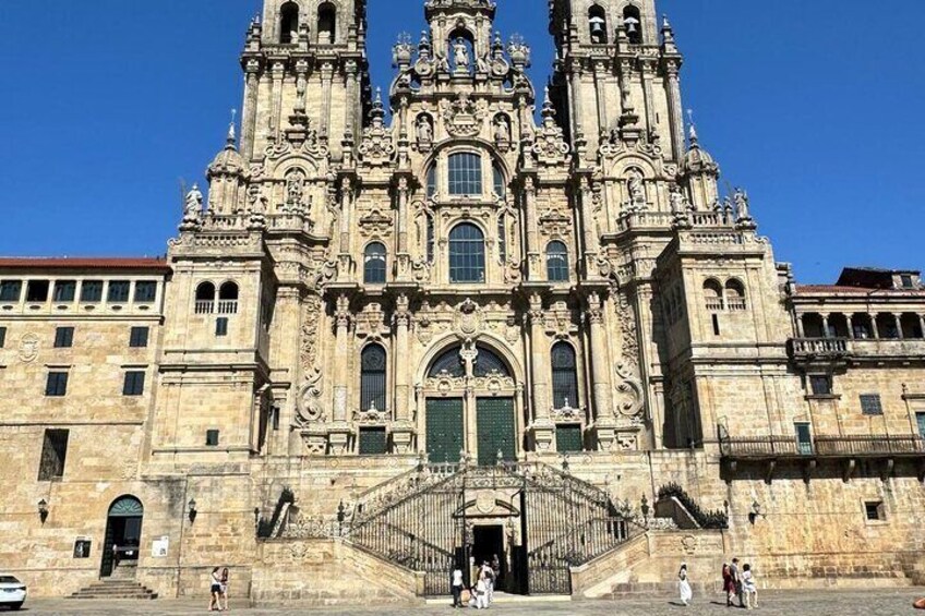 A grand, ornate cathedral with intricate architectural details, a prominent entrance, and a staircase leading up to it. 1