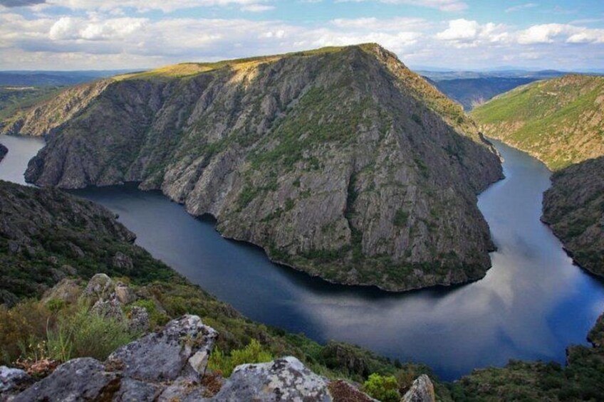 A mountainous landscape with a river. 1