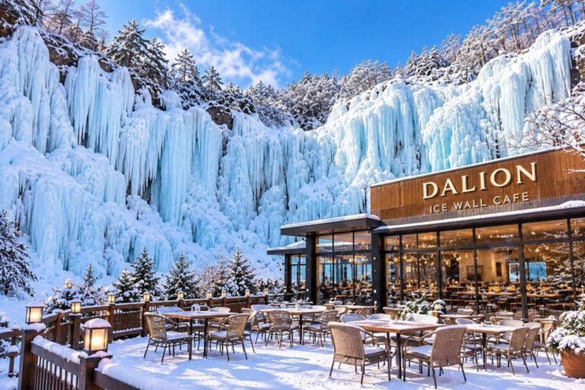 A snow-covered outdoor cafe named Dalion Ice Wall Cafe with tables and chairs. 4