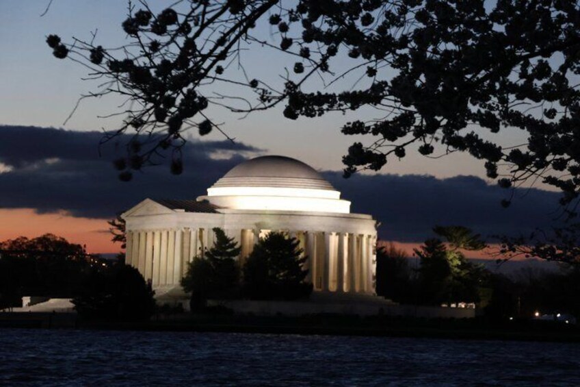A classical building with a dome, columns, and a waterfront backdrop. 5