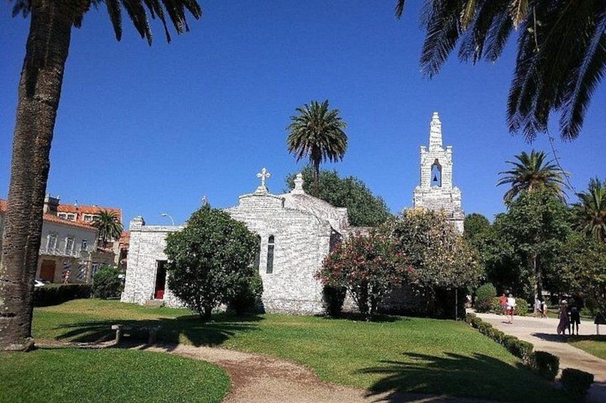 A church with a bell tower, surrounded by palm trees and a well-maintained lawn. 2