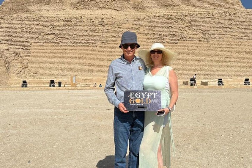 Two people holding a sign that reads 'EGYPT GOLD' in front of a large pyramid. 4