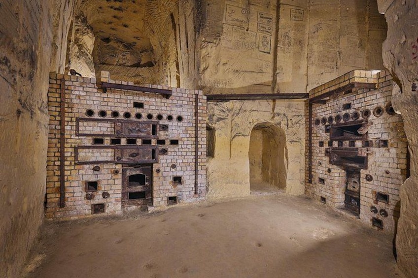 An ancient brick structure with arched doorways and circular openings. 2
