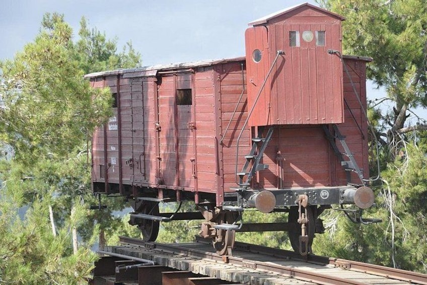 A red train caboose with a small cabin on a railway track. 1
