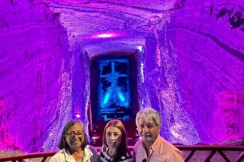 A tunnel with purple lighting and a central display. 3