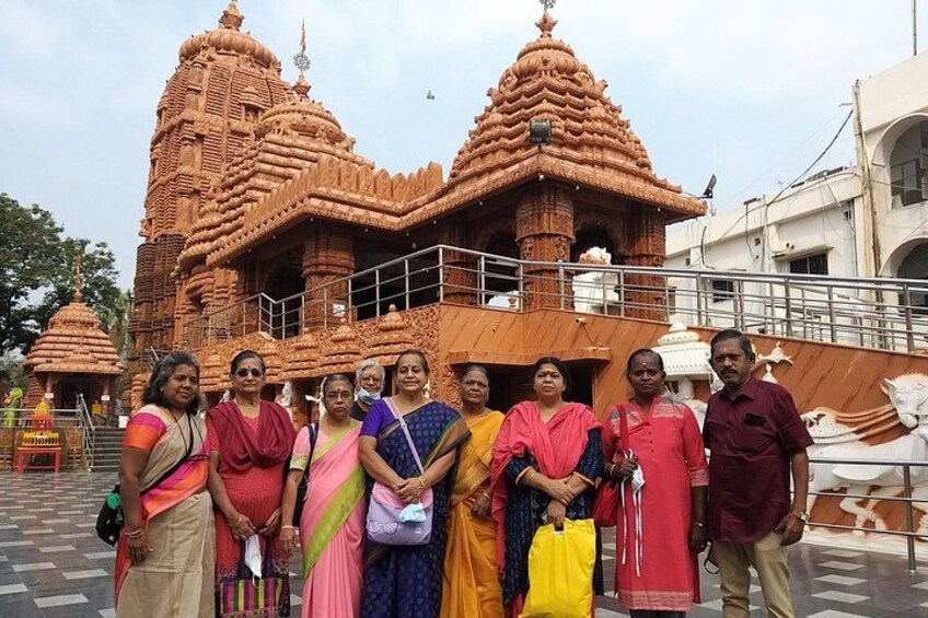 A group of people in front of a temple with intricate architecture. 2