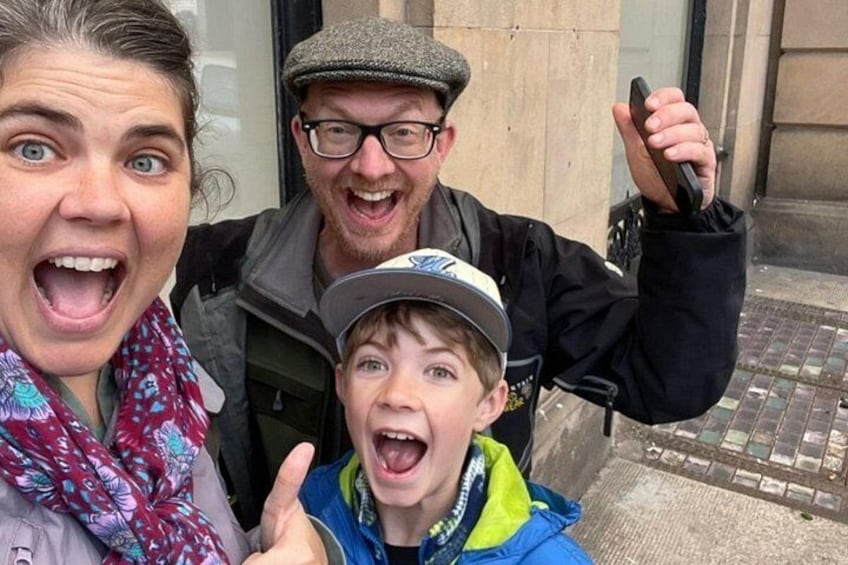 Three people taking a selfie with a building in the background. 2