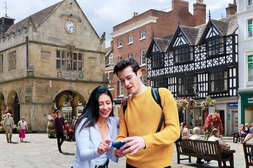 A historic building with a clock, a person in a yellow sweater, and another in a white jacket. 1