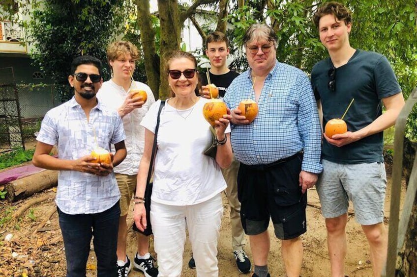 A group of people outdoors holding drinks and snacks. 1