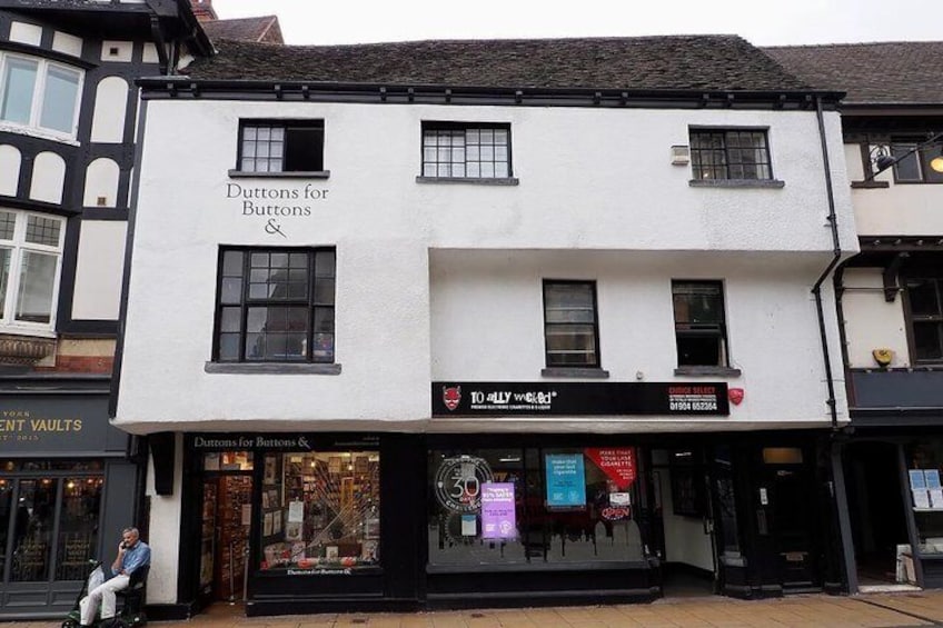 A white building with 'Duttons for Buttons' signage. 3