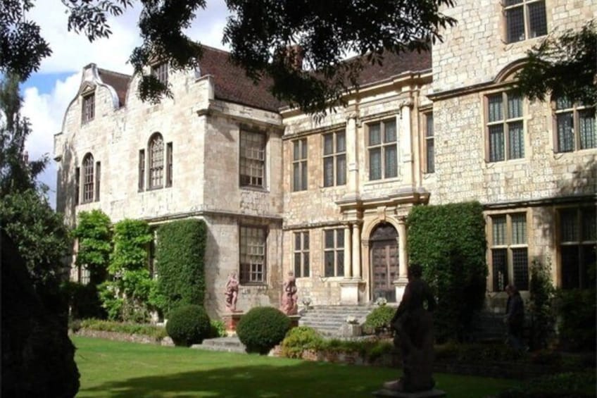 A historic stone building with arched windows and a central entrance. 4