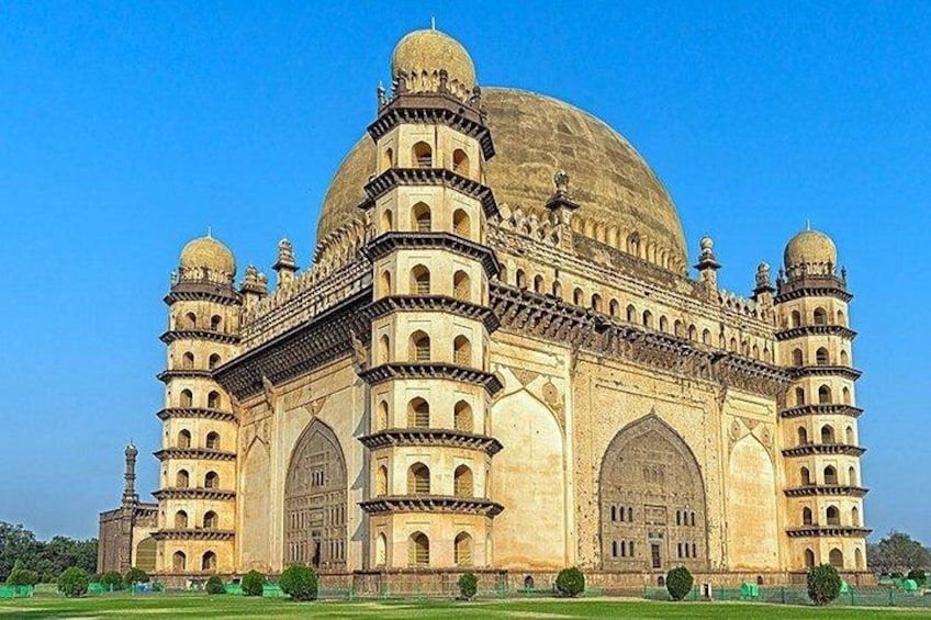 A large, historic building with multiple domes and arched windows. 1