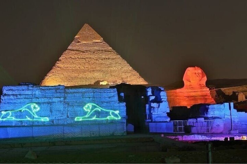 Illuminated pyramids and sphinx sculptures at night. 3
