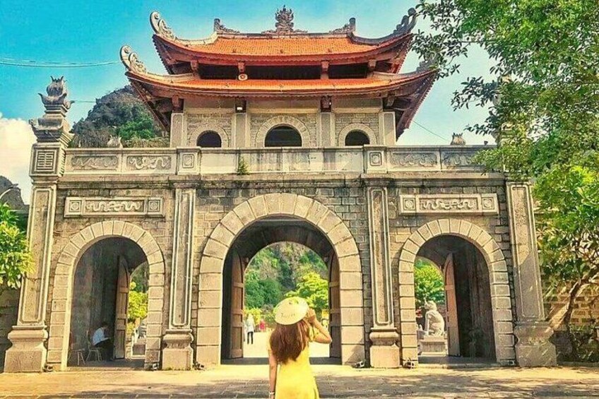A traditional gate with multiple arches and a tiled roof. 2