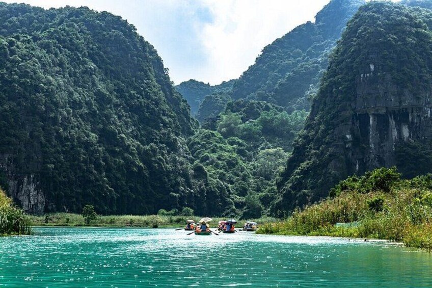 A river surrounded by lush green hills. 5
