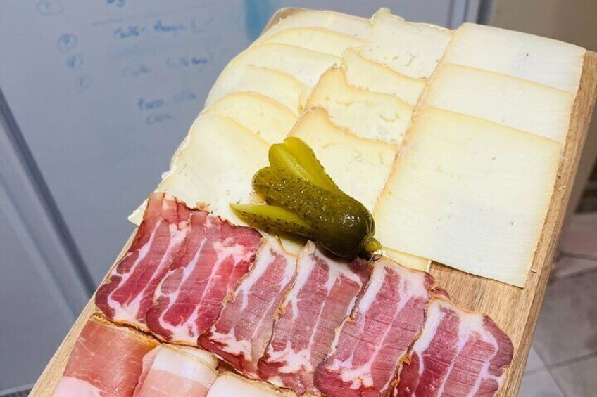 A charcuterie board with various meats and cheeses. 1