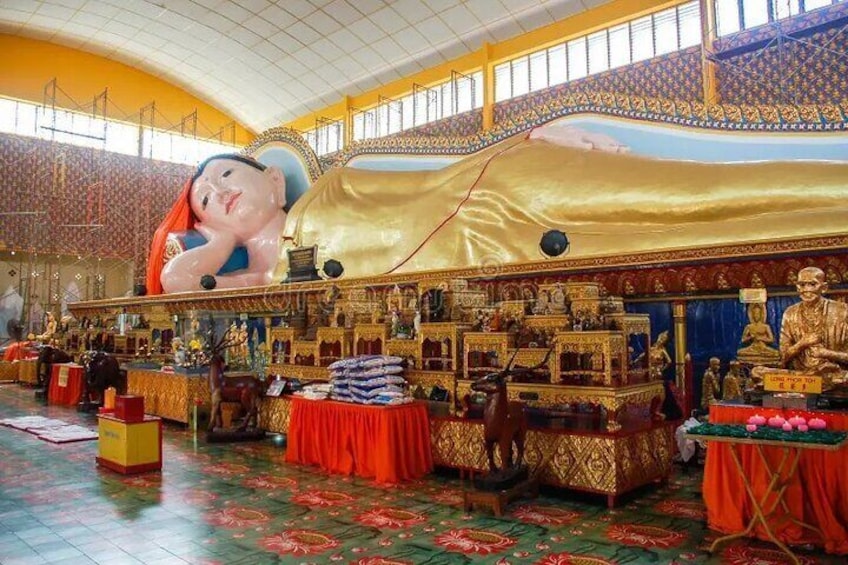 A large hall with golden decorations, statues, and a large mural. 1