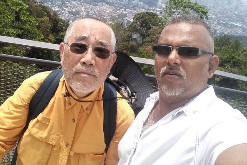 Two people taking a selfie with a cityscape in the background. 5