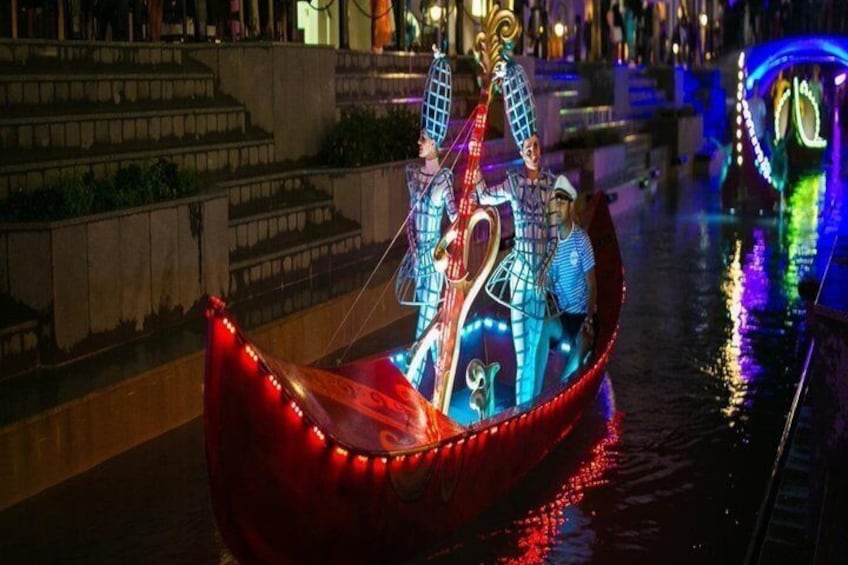 Eine Gondel mit beleuchteter Dekoration auf einem Kanal bei Nacht. 5