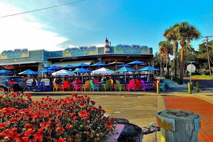 A restaurant with outdoor seating and colorful umbrellas. 2