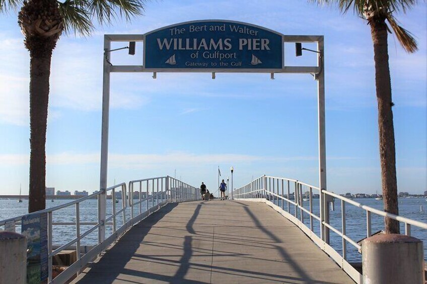 A pier with a sign reading "The Bernard Walter Williams Pier Gateway to the Gulf." 3