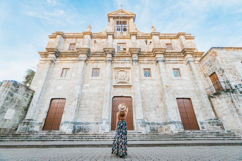 A historic church with a bell tower, large wooden doors, and a cobblestone street in front. 3