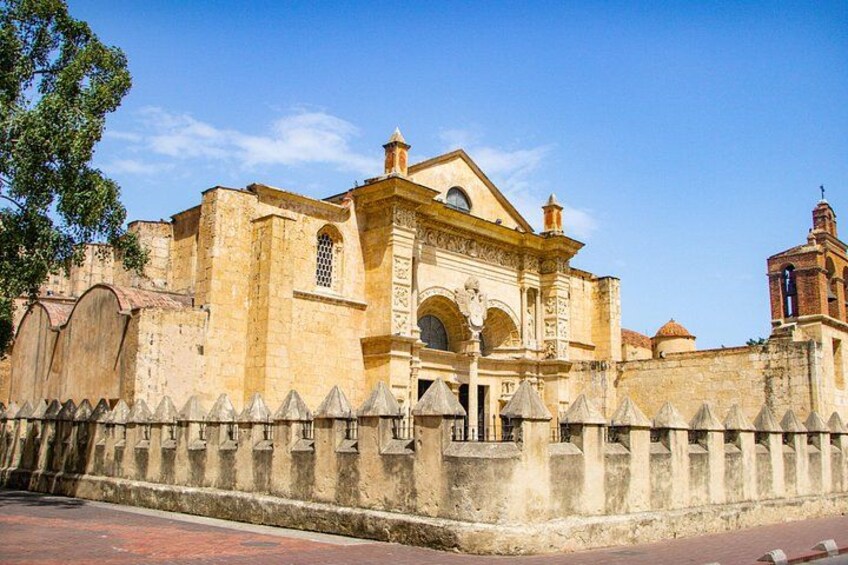 A historic building with a large archway and a bell tower. 5
