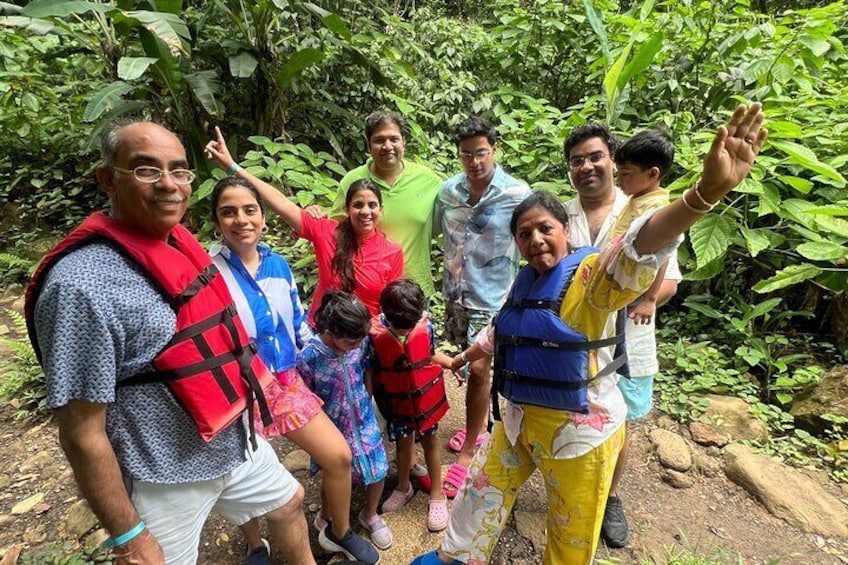A group of people wearing life jackets in a forested area. 5