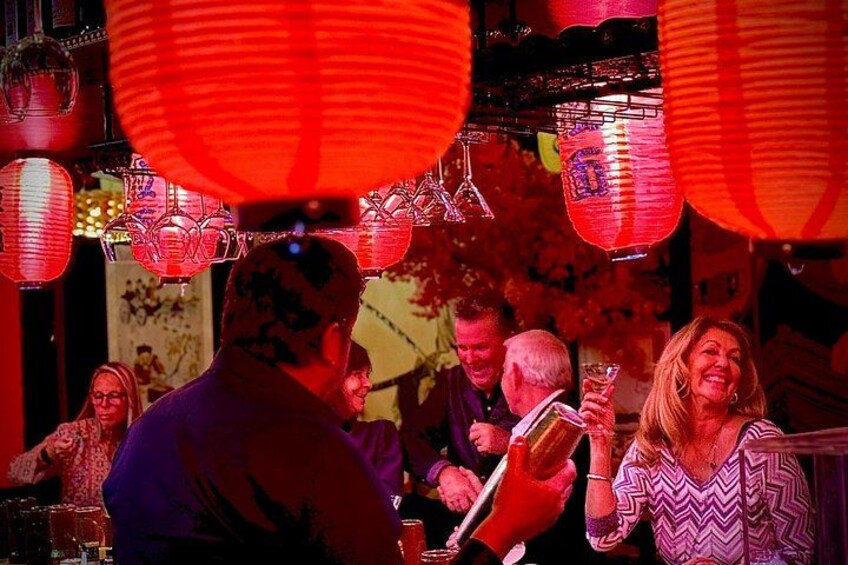 People dining in a restaurant with red lanterns overhead. 1