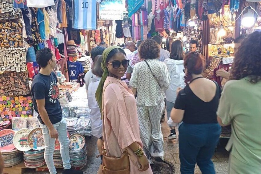 Een drukke markt met diverse kraampjes die spullen verkopen. 2