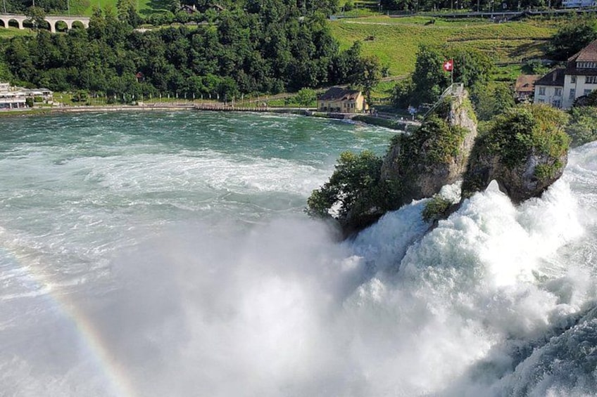 A waterfall, a rainbow, and a bridge. 5