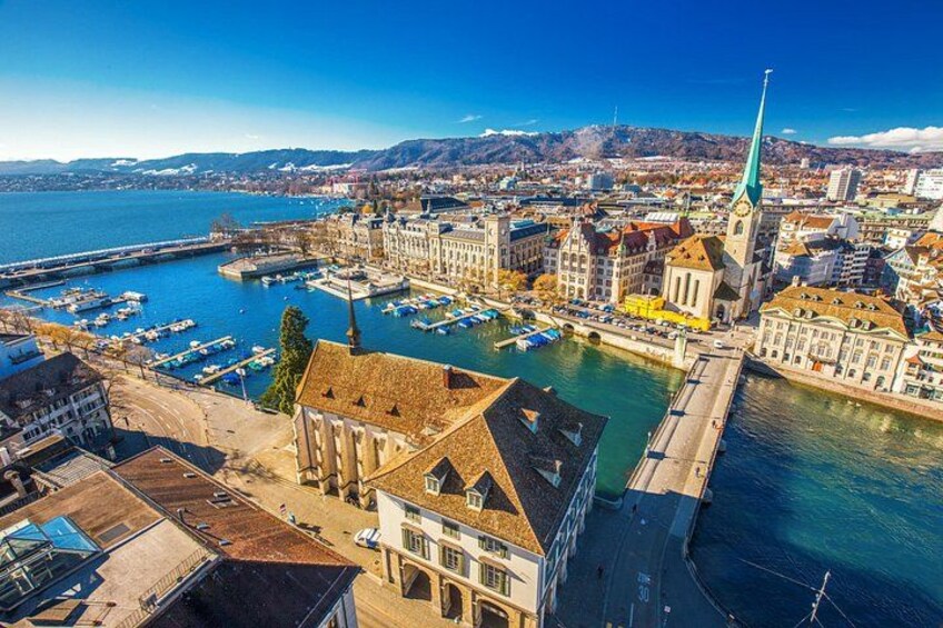 A coastal city with a prominent church, a marina, and a river. 4