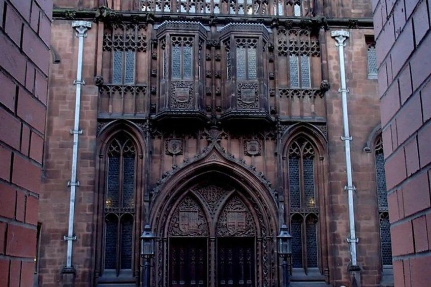 A Gothic-style building with intricate window designs and a large arched entrance. 4