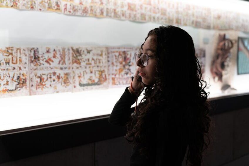 A person standing in front of a wall with colorful patterns. 1