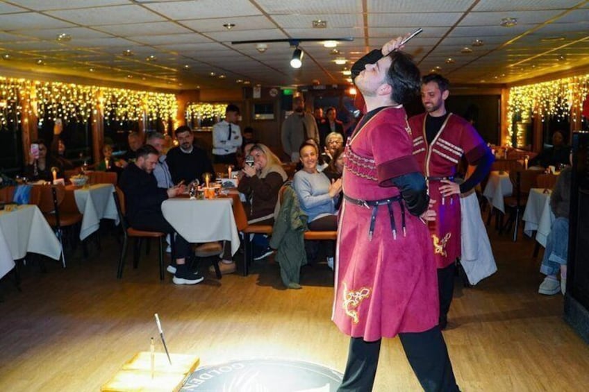 A person in a red costume performing in a restaurant with tables and diners. 5