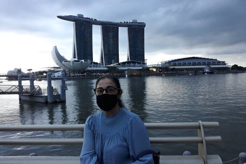 A person on a boat with the Marina Bay Sands hotel in the background. 2