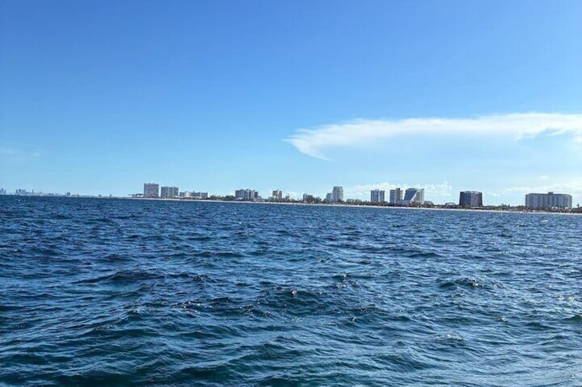 Un paysage urbain côtier, avec un ciel bleu dégagé et une mer calme. 5