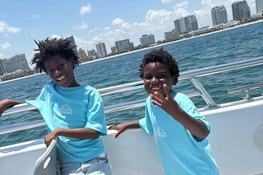 Two people on a boat with a city skyline in the background. 2