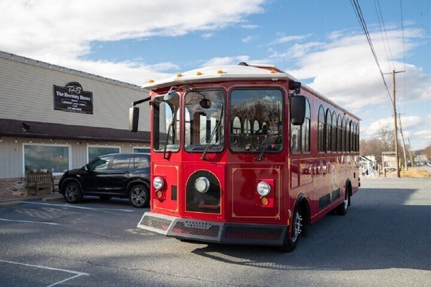 A red bus parked in front of a building with a sign that reads "The Berkshire Bus." 5