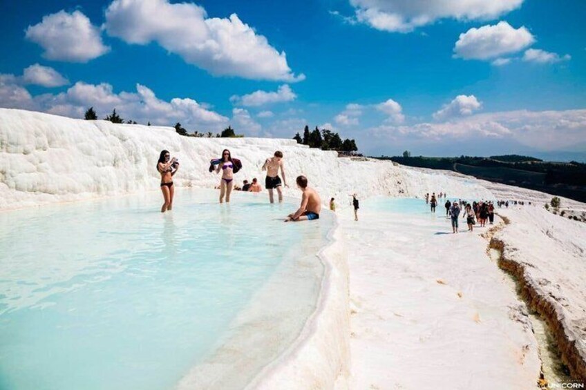 A geothermal spa with people enjoying the water. 3