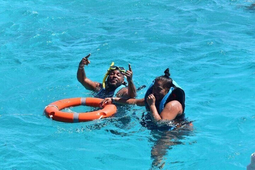 Two people in a pool with a lifebuoy. 2