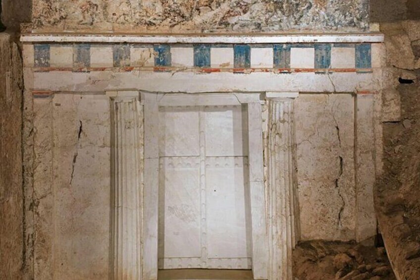A weathered stone doorway with a decorative frieze above it. 2